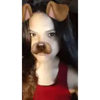 a girl with long hair is wearing a dog mask .