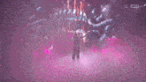 a woman with long hair is standing in front of a stage with purple lights and smoke