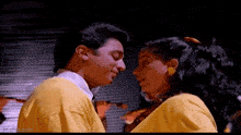 a man and a woman are kissing each other in a movie .