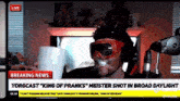 a man wearing goggles is drinking from a cup in front of a breaking news headline