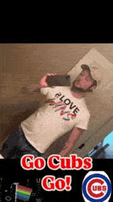 a man taking a selfie with a cubs shirt on