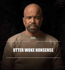 a bald man with a beard is wearing a sweater that says utter woke nonsense on it