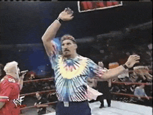 a man in a tie dye shirt with the number 03 on his jersey