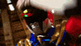 a close up of a person wearing a red and blue armor