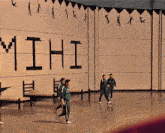 a group of people are walking in front of a wall that says ' mihi ' on it