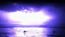 a purple lightning strike over the ocean