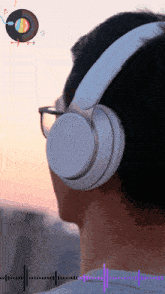 a man wearing white headphones with a record on the background