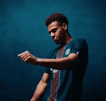 a man wearing a blue shirt that says a on it