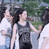 a girl wearing a nypd 14 jersey