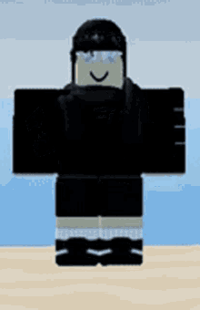 a roblox character is standing on a beach wearing a black hoodie and black shorts .