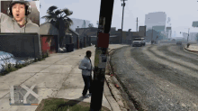 a man wearing headphones is playing a video game with a wanted poster on a pole