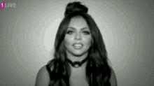a black and white photo of a woman with long hair wearing a choker .