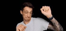 a man with a tattoo on his arm is wearing a darth vader helmet
