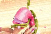 a woman in a pink dress is doing a handstand on a vine