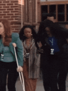 a woman with crutches and a name tag that has the letter j on it