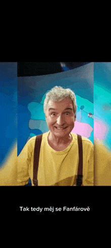 a man in a yellow shirt and brown suspenders is smiling with the words tak tedy mej se fanfarove below him