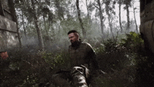 a man with a beard is standing in the middle of a forest in a video game .