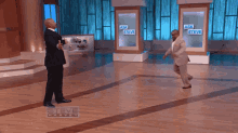 a steve harvey show with two men fighting on the floor
