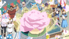 a group of people are gathered around a large pink flower