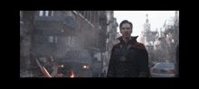 doctor strange is standing in front of a building that has the word tower on it