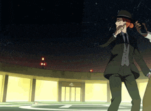 a man in a suit standing in front of a building with the number 4 on it
