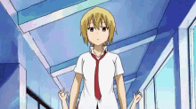 a girl in a white shirt and red tie is walking down a hallway .