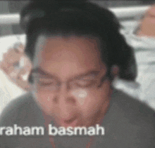 a close up of a man 's face with the words " raham basmah " written on the bottom