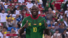 a soccer player wearing a number 10 jersey is giving a thumbs up