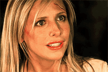 a close up of a woman 's face with a wound on her forehead