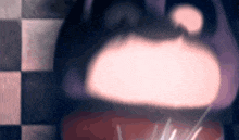 a blurred image of a cartoon character with a checkered floor in the background