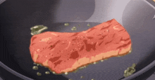 a piece of meat is cooking in a frying pan