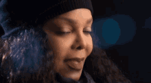 a close up of a woman 's face with smoke coming out of her nose .