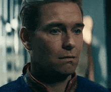 a close up of a man 's face with a sad look on his face