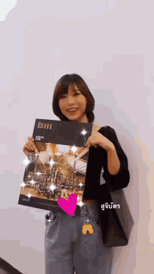 a woman is holding a book titled bill