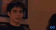 a man and a woman are talking to each other in a room .