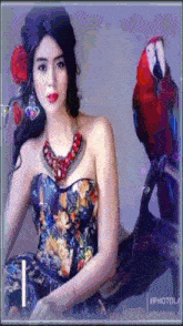 a woman in a floral dress is sitting next to a parrot .