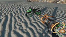 a green dirt bike is driving through the sand