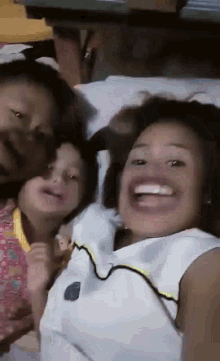 a group of children are laying on a bed and one of them is wearing a shirt that says ' nba ' on it