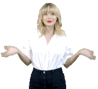 a blonde woman wearing a white shirt and black pants spreads her arms