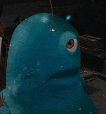 a blue cartoon character with a big eye looks at the camera
