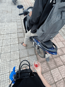 a person sitting on a scooter with a license plate that says gd 016 44