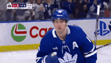 a hockey player wearing a jersey that says toronto on it