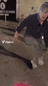 a person wearing glasses and a black shirt is dancing on a street with the words viggle.ai visible in the corner