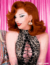 a woman with red hair is wearing a leopard print top with a plunging neckline