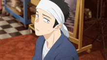 a man with a headband on his head looks up at something