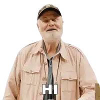 a man with a beard wearing a hat and a jacket says hi