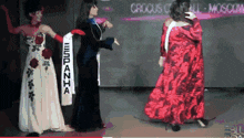 a woman in a red dress has a sash that says espana on it