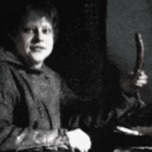 a black and white photo of a person holding a stick