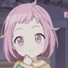 a little girl with pink hair is wearing a yellow sweater and making a face .