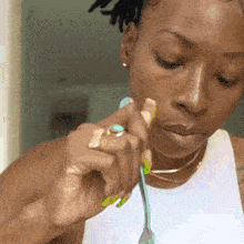 a woman with a ring on her finger holds a fork